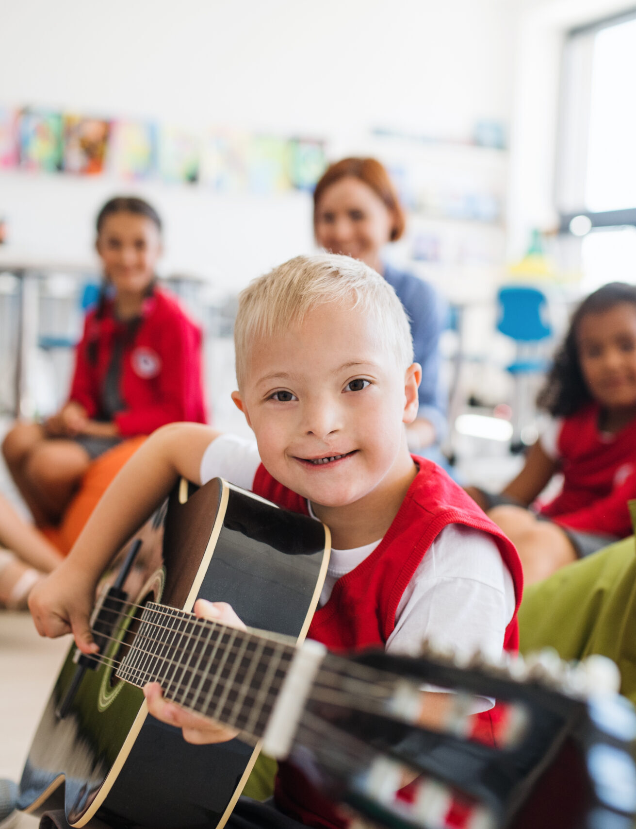 yound boy with down syndrome playing guitar