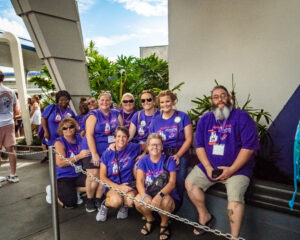 smiling people wearing purple shirts at Disney