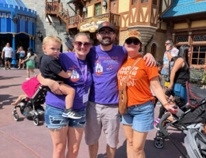 young family smiling at disney