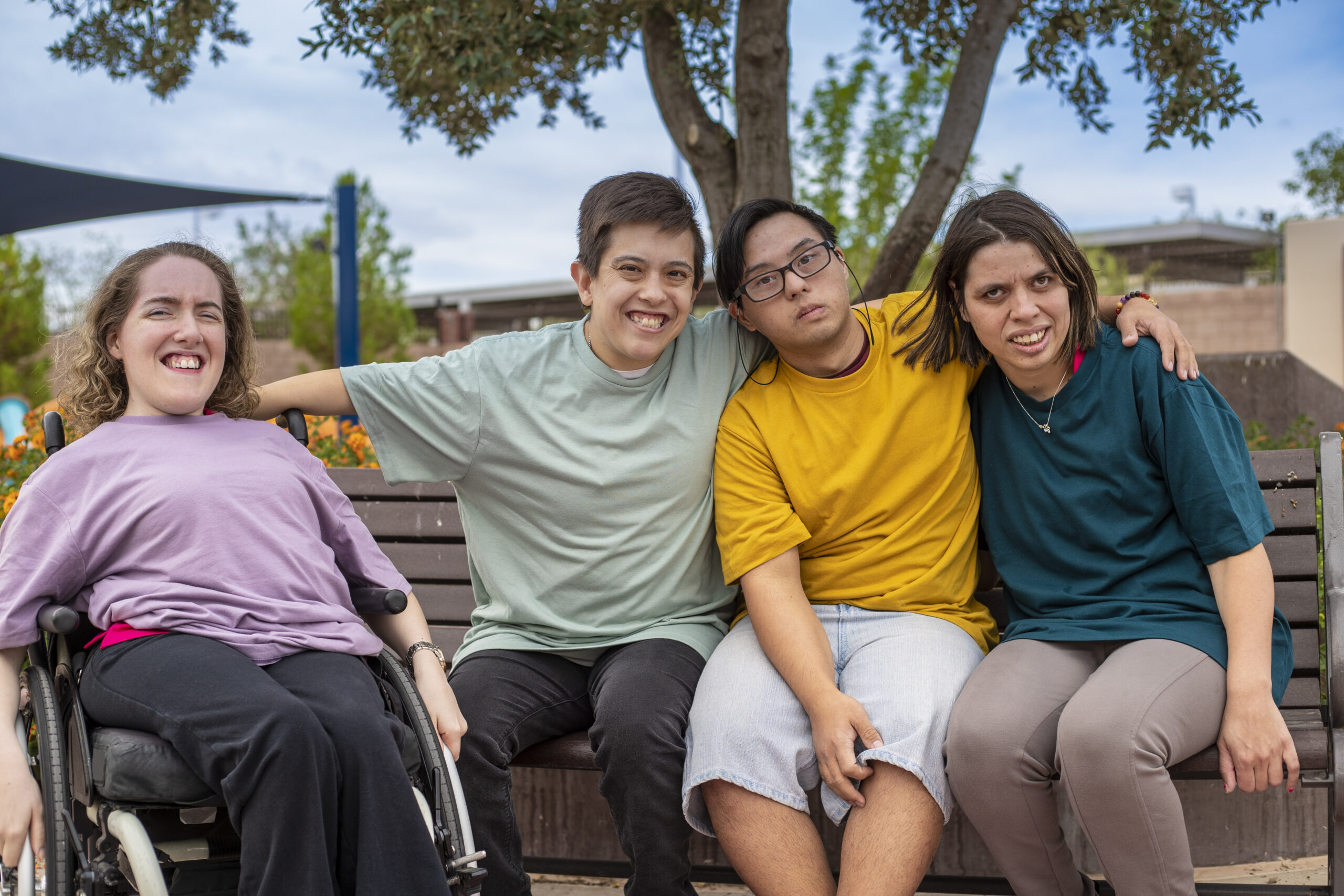 image of young adult with disabilities sitting together on bench