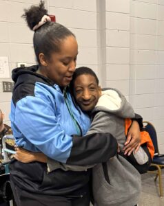 young man with disabilities smiling with caregiver