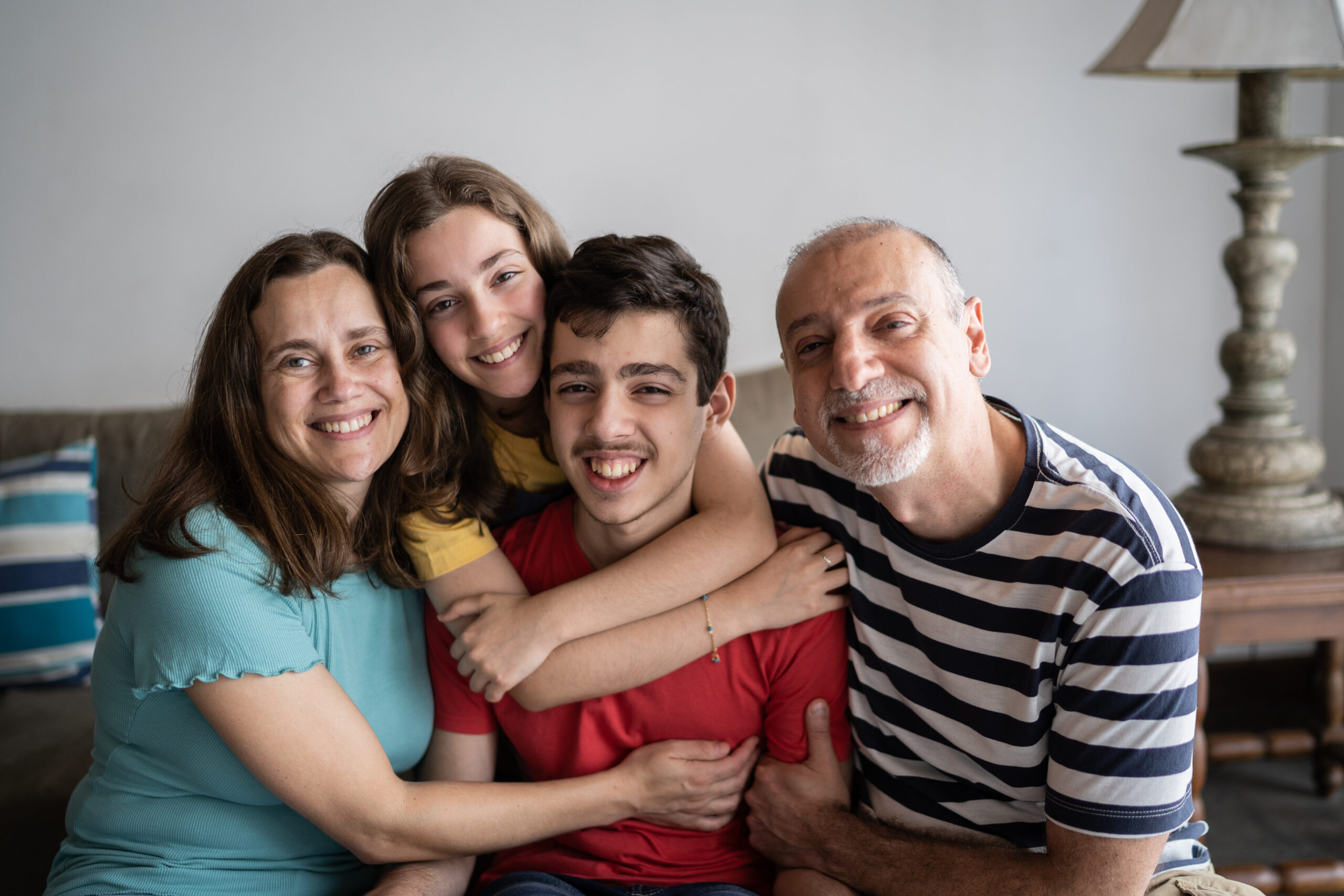 Portrait of a family at home with young man with disabilities