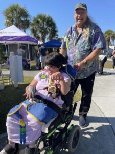 young woman with disabilities sittting in wheelchair with caregiver